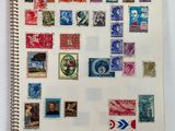 a notebook with a lot of different stamps on it