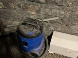 a vacuum cleaner that is sitting on the floor next to a box