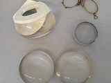 a pair of glasses, a pair of glasses, and a pair of eyeglasses on a table
