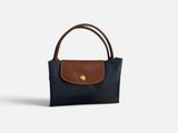 a small black and brown purse with a brown handle
