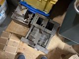 a person standing on a wooden floor next to a yellow box