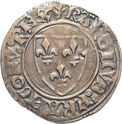 a close up of a silver coin with a shield on it