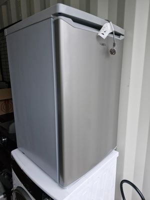 a refrigerator sitting on top of a refrigerator freezer