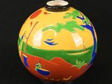 a vase with a painting on it on a black background
