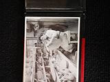 a cigarette case with a picture of a man working on a machine