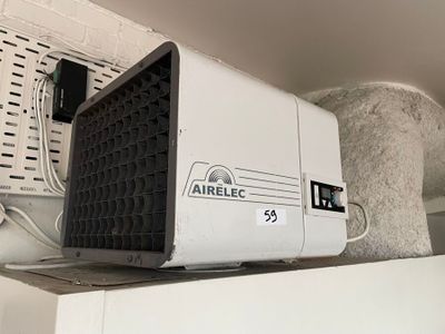 a small air conditioner sitting on top of a shelf