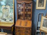 a lot of antique furniture in a room with blue walls