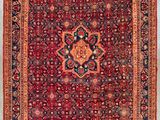 a red and blue rug with a medallion design on it