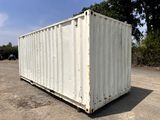 a white container sitting in the middle of a parking lot