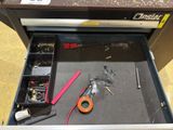 a tool drawer with tools in it on the floor