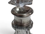 a glass bottle with a diamond on top of it