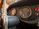 dashboard of an old car with a steering wheel and gauges