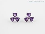 a pair of amethorate earrings with diamonds on a white background
