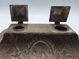 a large metal object with two monitors on top of it