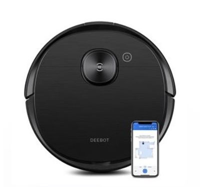 un aspirateur robot noir avec un téléphone à côté