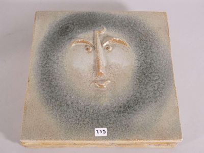 a ceramic box with a face painted on it