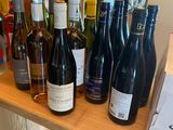 bottles of wine are lined up on a shelf in a store