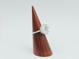 a close up of a ring on top of a wooden cone