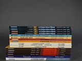 several books are stacked on top of each other on a table