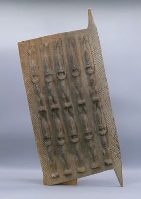a sculpture of a wooden block with a number of people on it