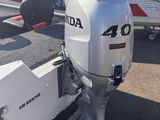 a motor boat that is parked next to other boats