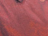 a close up of a red shirt with buttons on it