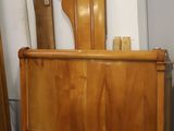a bed with a wooden headboard and foot board in a room