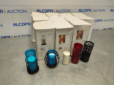 four different colored candles sitting next to each other on the floor