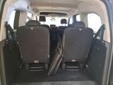two seats in the back of a van with the door open