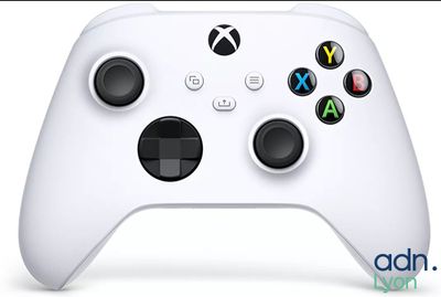 a close up of a white controller on a white surface