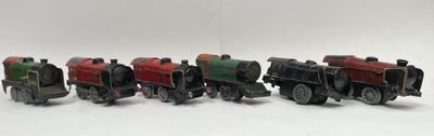 several toy trains are lined up in a row on a white surface