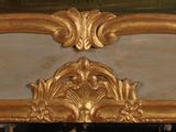 a mirror with a gold frame on the wall