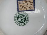 a white plate with a blue and green label on it
