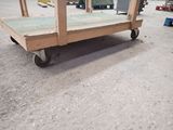 a wooden cart that is sitting in the middle of the street