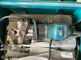 a blue box with a drill and some newspaper in it