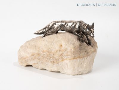 a sculpture of a wolf on a rock on a white surface