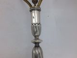 an antique silver plated lamp with a glass shade hanging from it ' s side