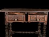 a wooden table with two drawers on top of it