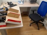 a desk with a chair and a box on top of it