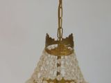 a brass and glass chandelier hanging from a ceiling