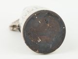 a close up of a metal object on a white surface