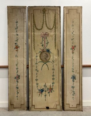 two antique wooden doors with floral designs on them in a room