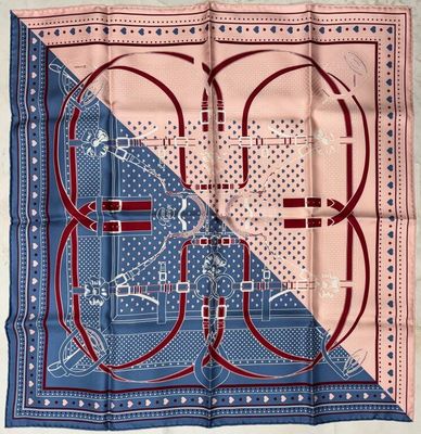 a close up of a blue and pink scarf with a design on it