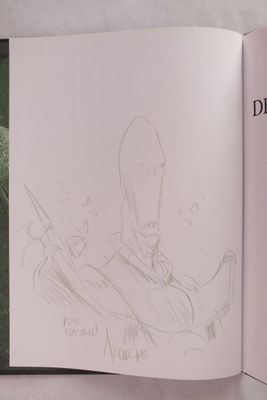 un livre ouvert sur lequel figure le dessin d'un homme en costume-cravate
