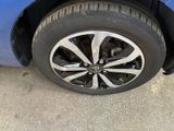 a close up of a tire on a blue car