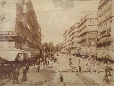 an old picture of a city street with people walking on it
