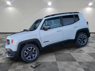 a white jeep is parked in a room with a checkered floor