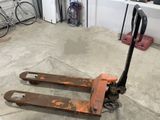 a fork lifter sitting on the floor in a garage
