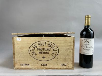 an old wooden box with a bottle of wine next to it