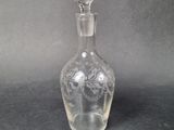an image of a clear glass decanter on a table
